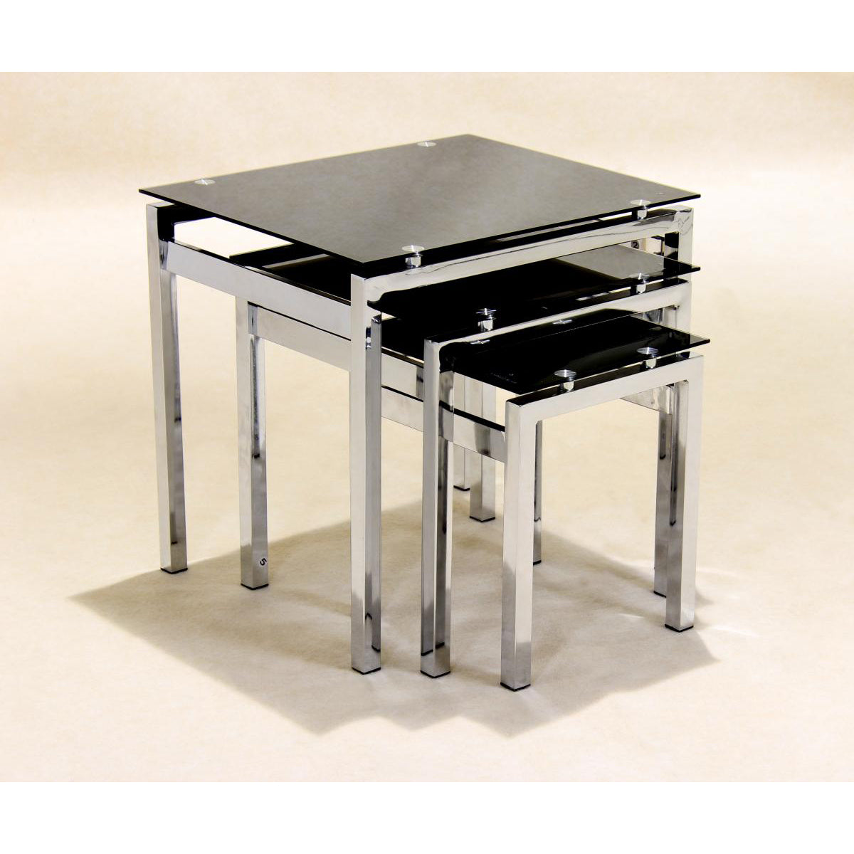 A set of three nesting tables with black glass tops and silver chrome legs, positioned together in a stacked arrangement.