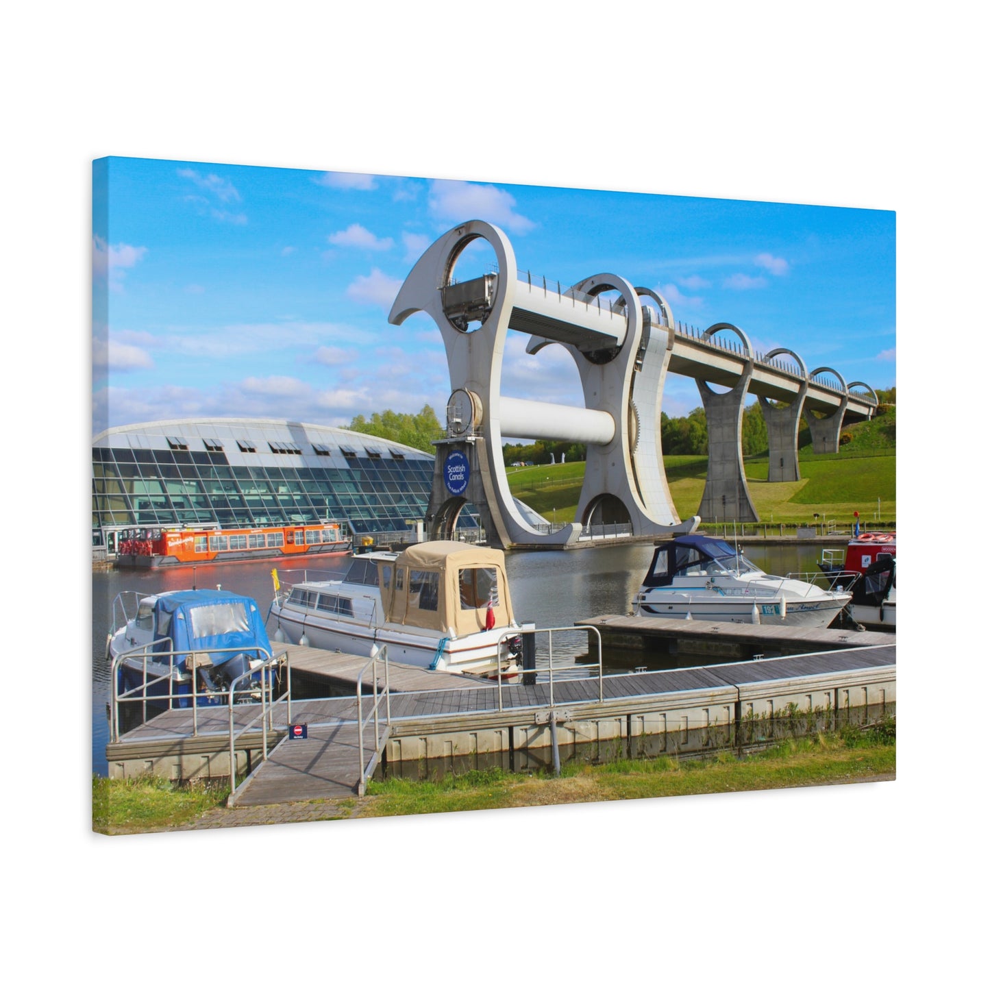 Modern water control structure with boats docked nearby on a clear day.