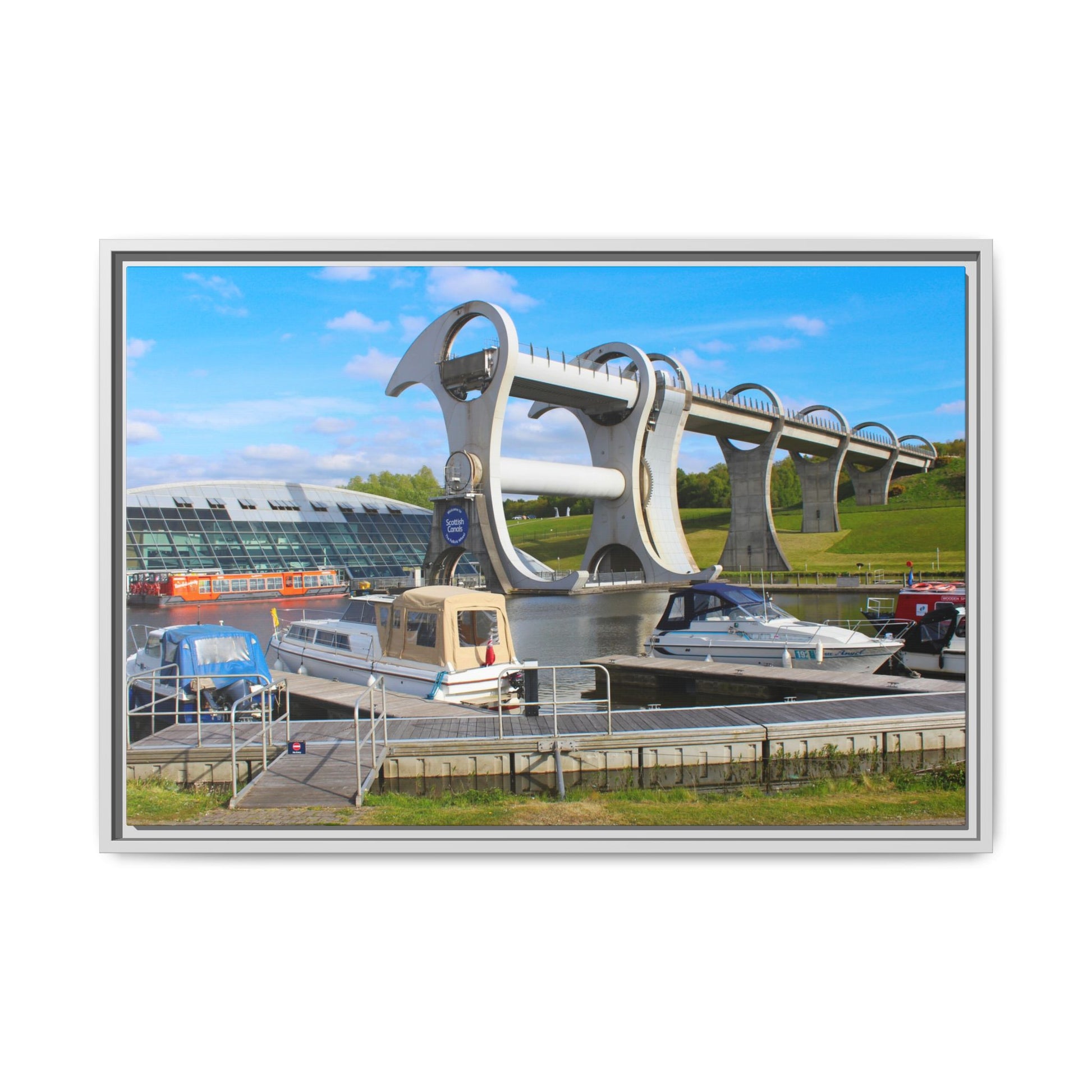 Falkirk Wheel boat lift with boats docked below on a clear day