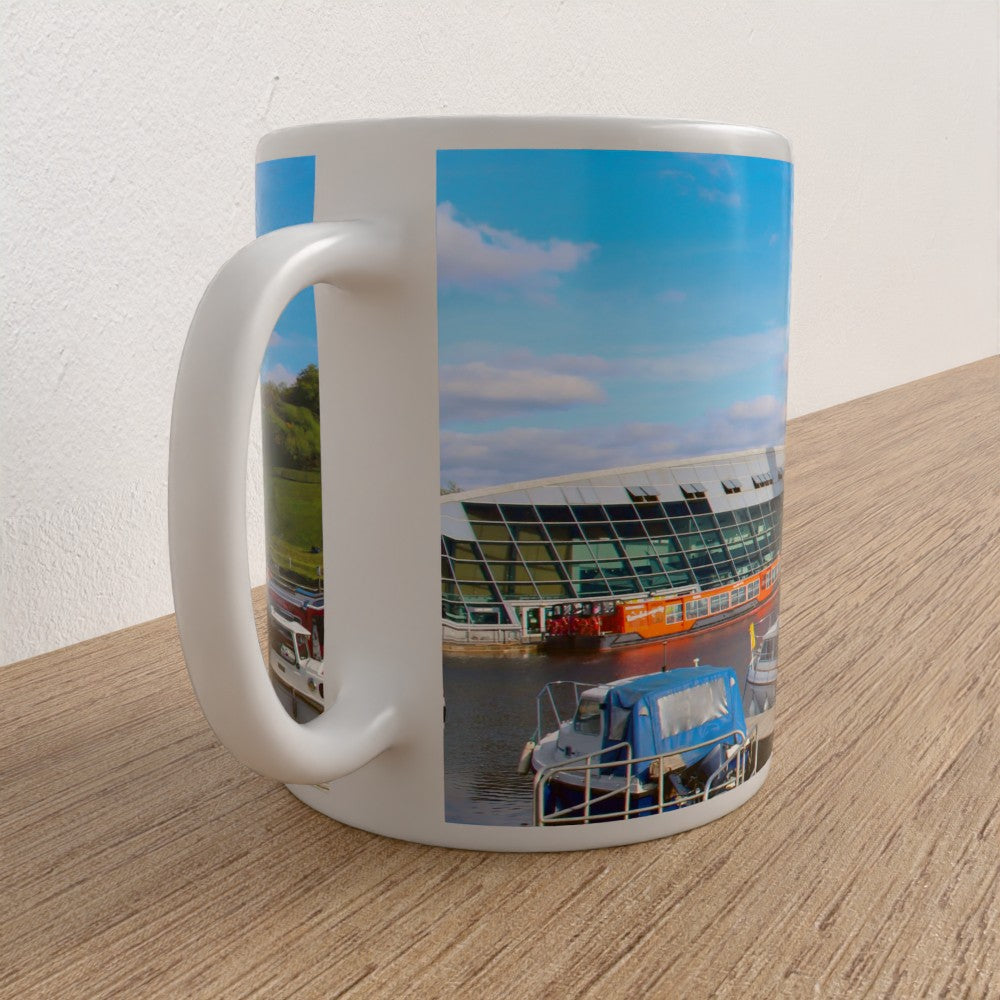White mug with a printed design of a boat lift and boat on a wooden surface