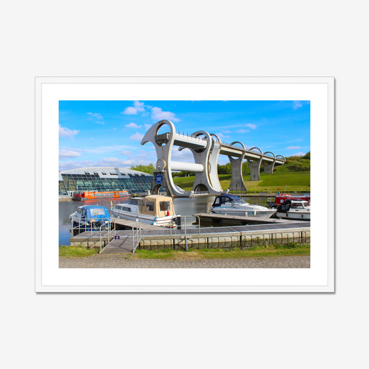 Falkirk Wheel boat lift with boats docked at a pier on a clear day.
