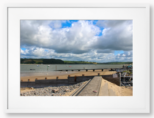 Framed Photo of a Beach scene with a large body of water, sky with clouds, and distant hills.