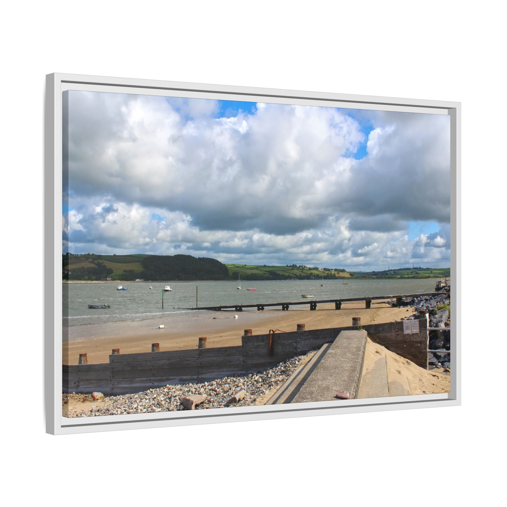Framed picture of a coastal scene with a beach, water, and sky.
