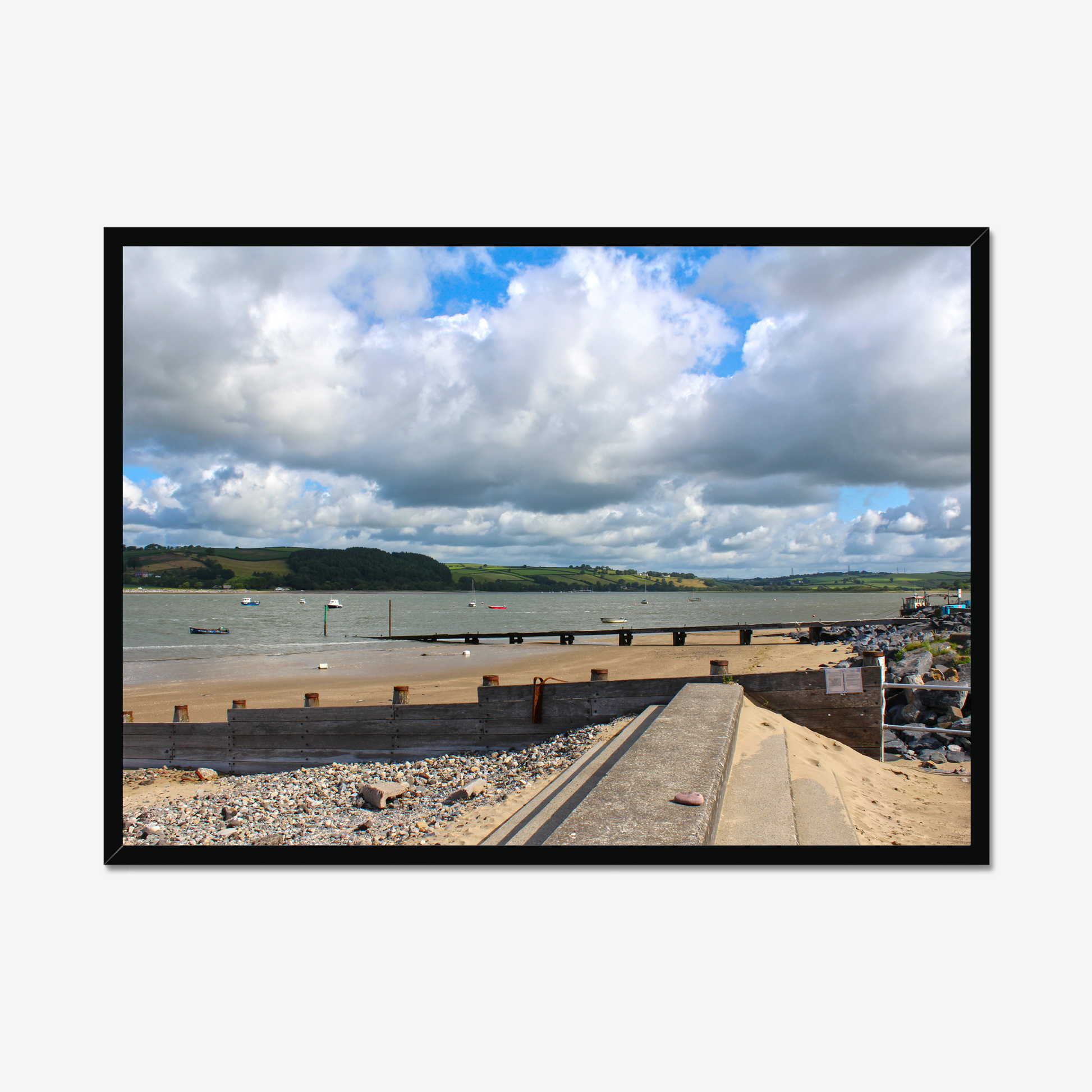 Framed photograph of a coastal scene with a dock and cloudy sky.