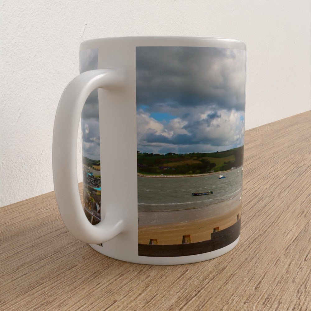 Mug with a scenic coastal view on a wooden surface