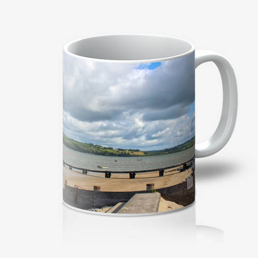 Mug with a scenic coastal view on a white background