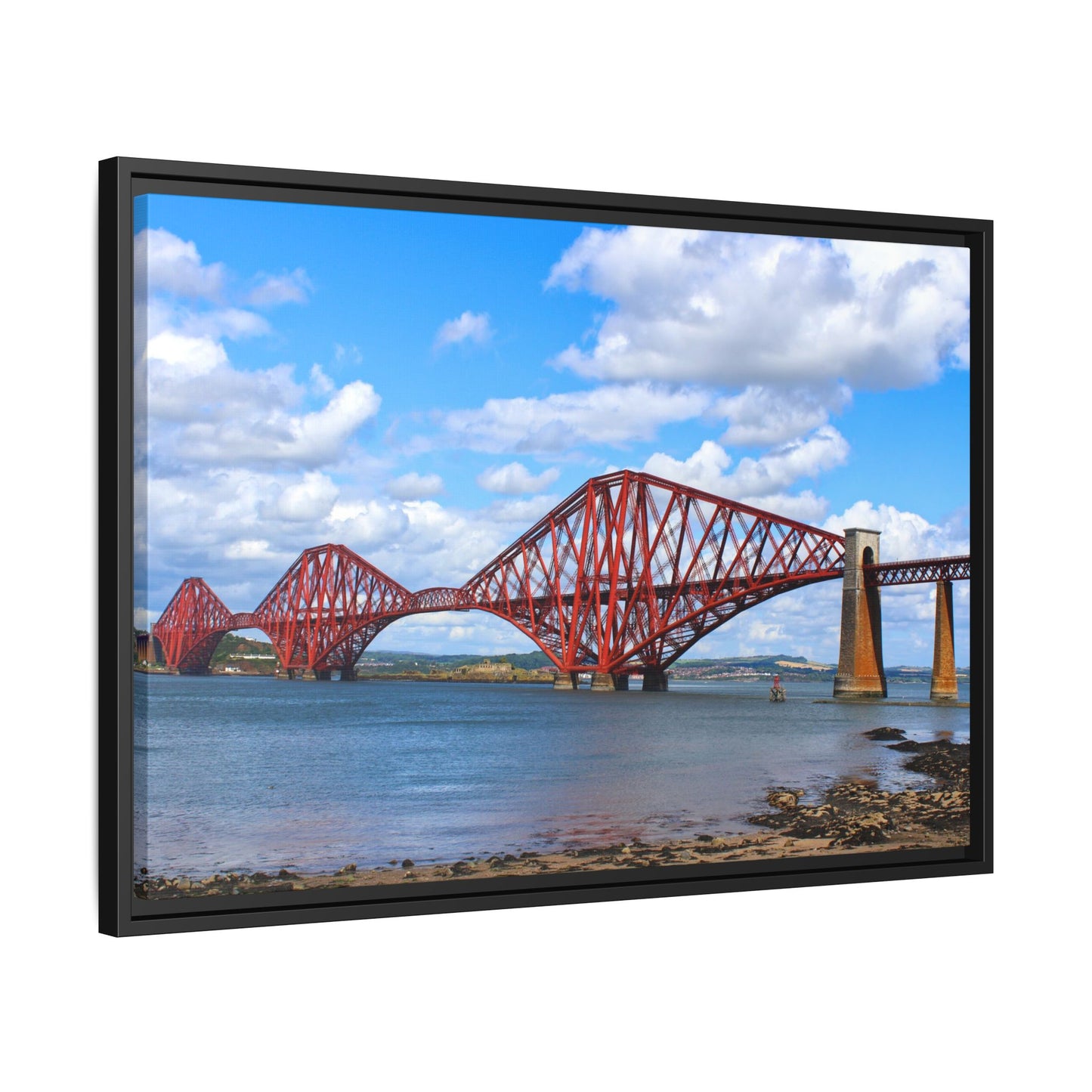 Framed picture of a red bridge over water with a blue sky.