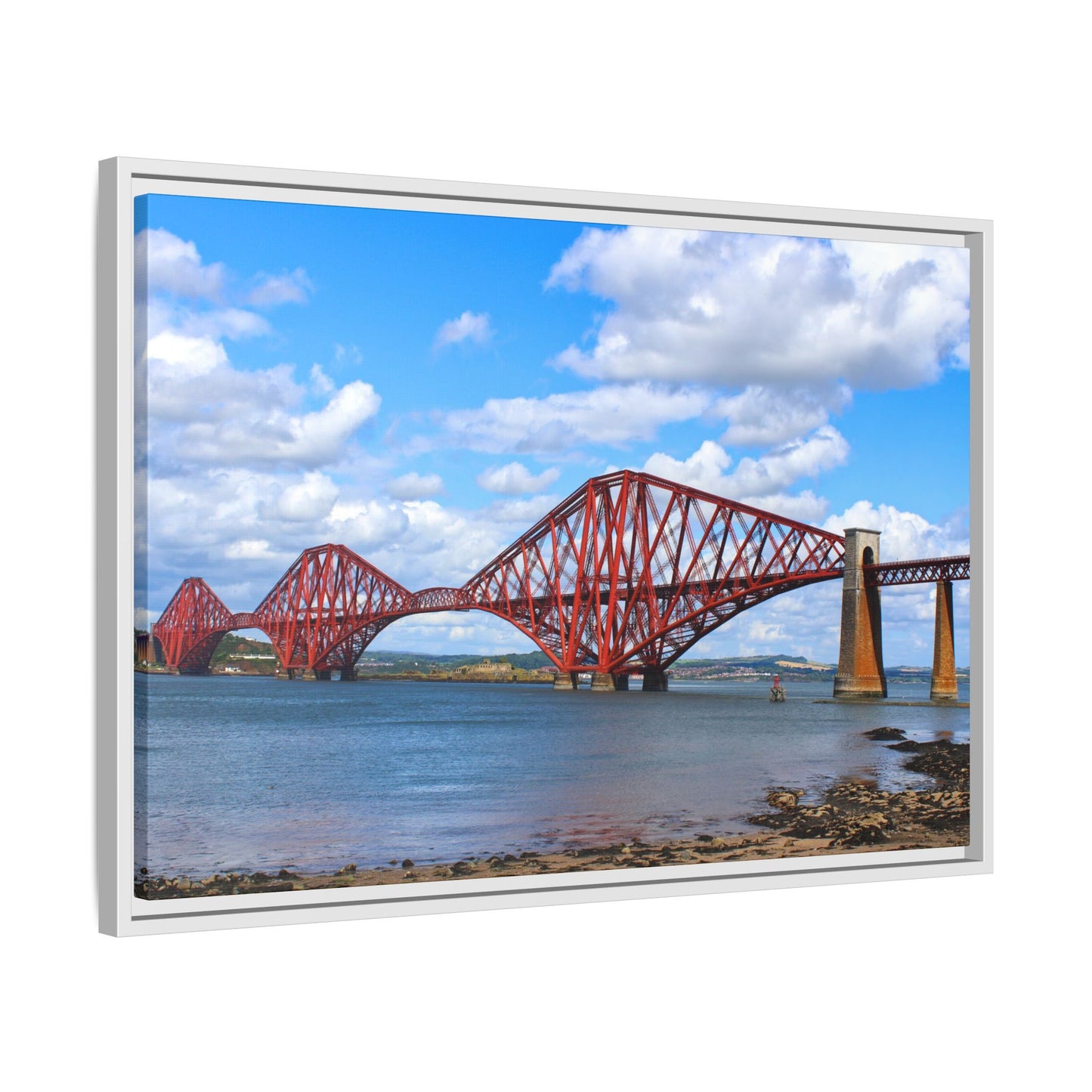 Framed picture of a red bridge over water with a blue sky.