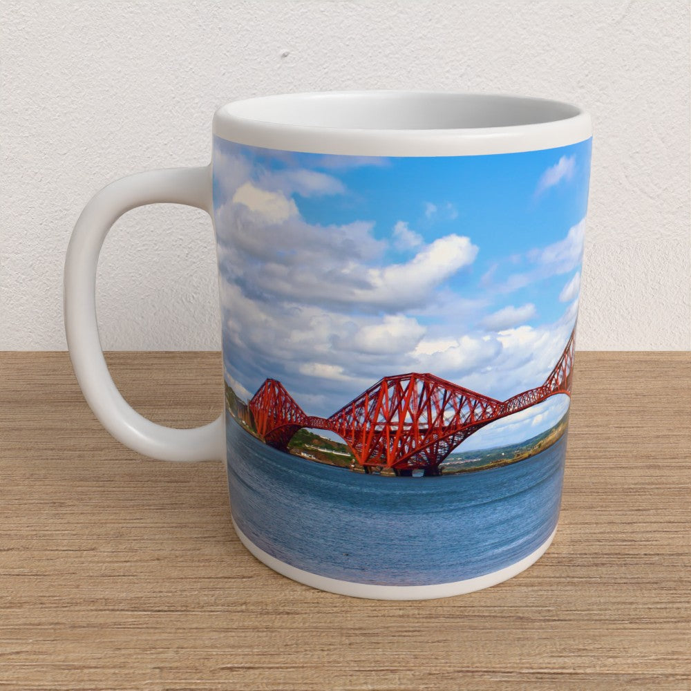 Mug with a design of the Forth Rail Bridge on a wooden surface
