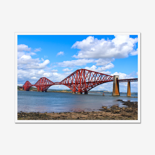 Framed photograph of a red bridge over water with a blue sky.