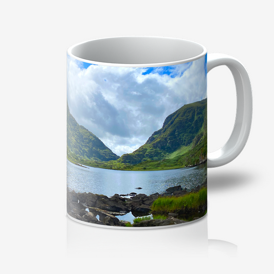 Mug with a scenic design of a lake and mountains on a white background