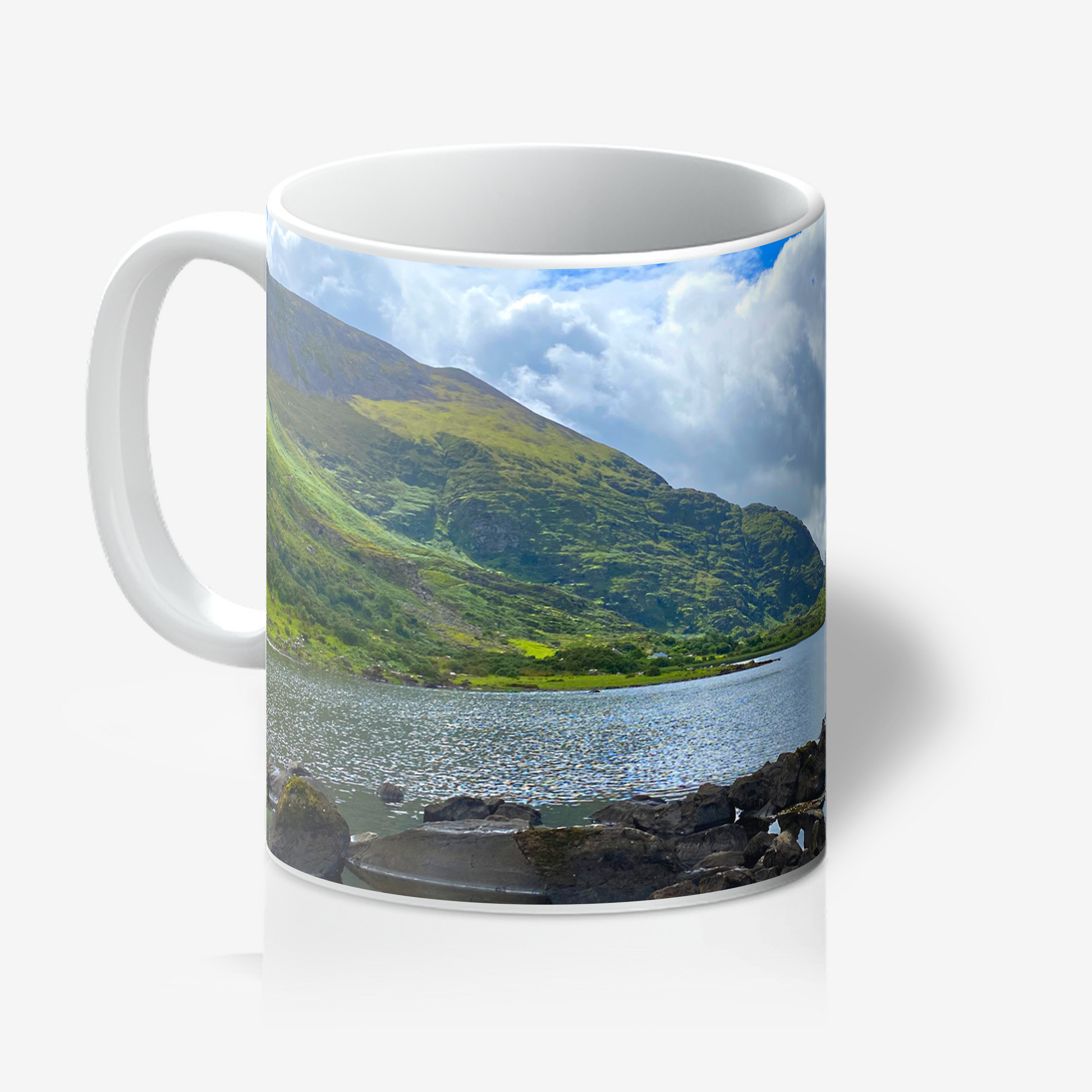 Mug with a scenic design of a lake and mountains on a white background