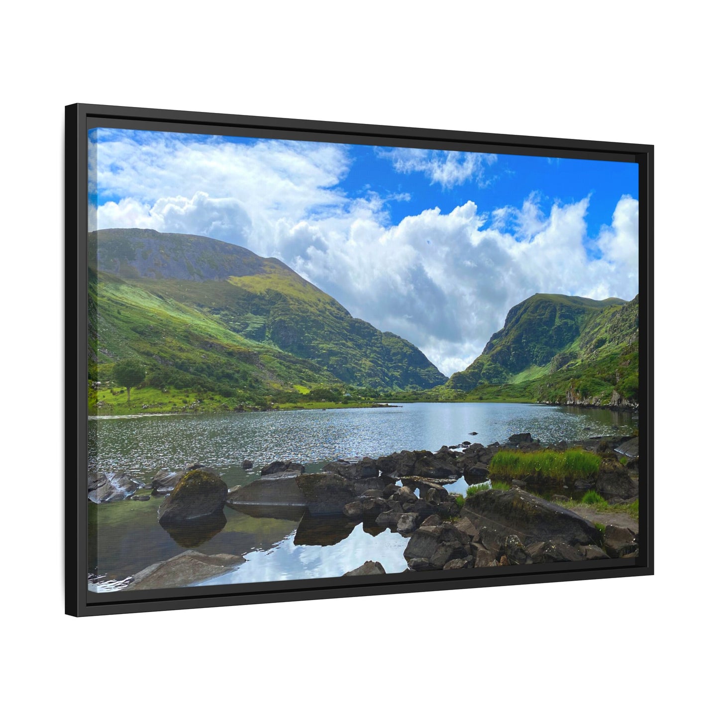 Framed landscape print of a mountainous scene with a lake and blue sky.