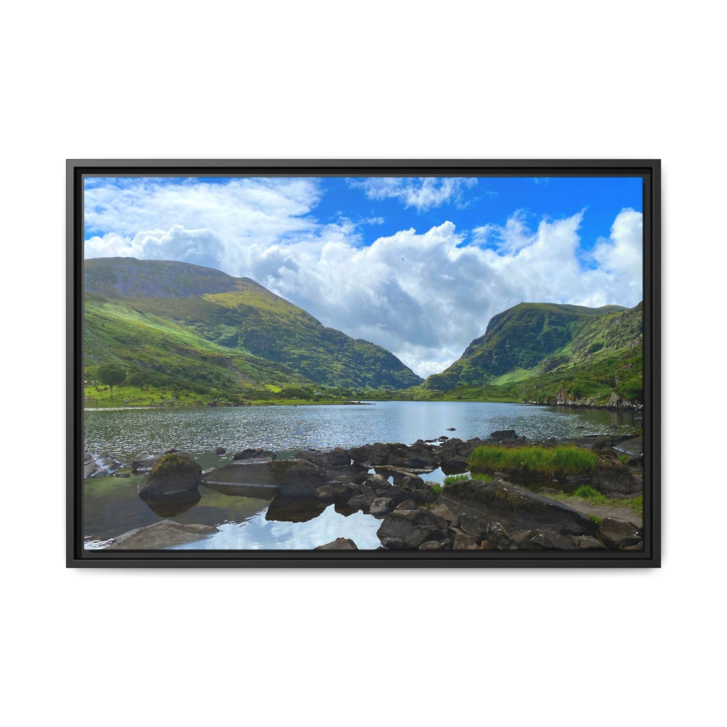 Framed picture of a scenic landscape with a lake and mountains.