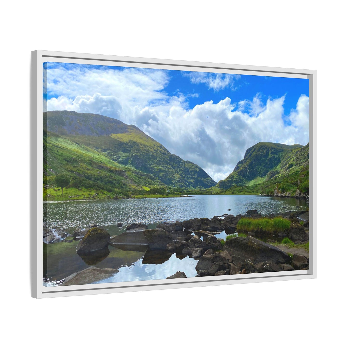 Framed picture of a scenic landscape with a lake and mountains.