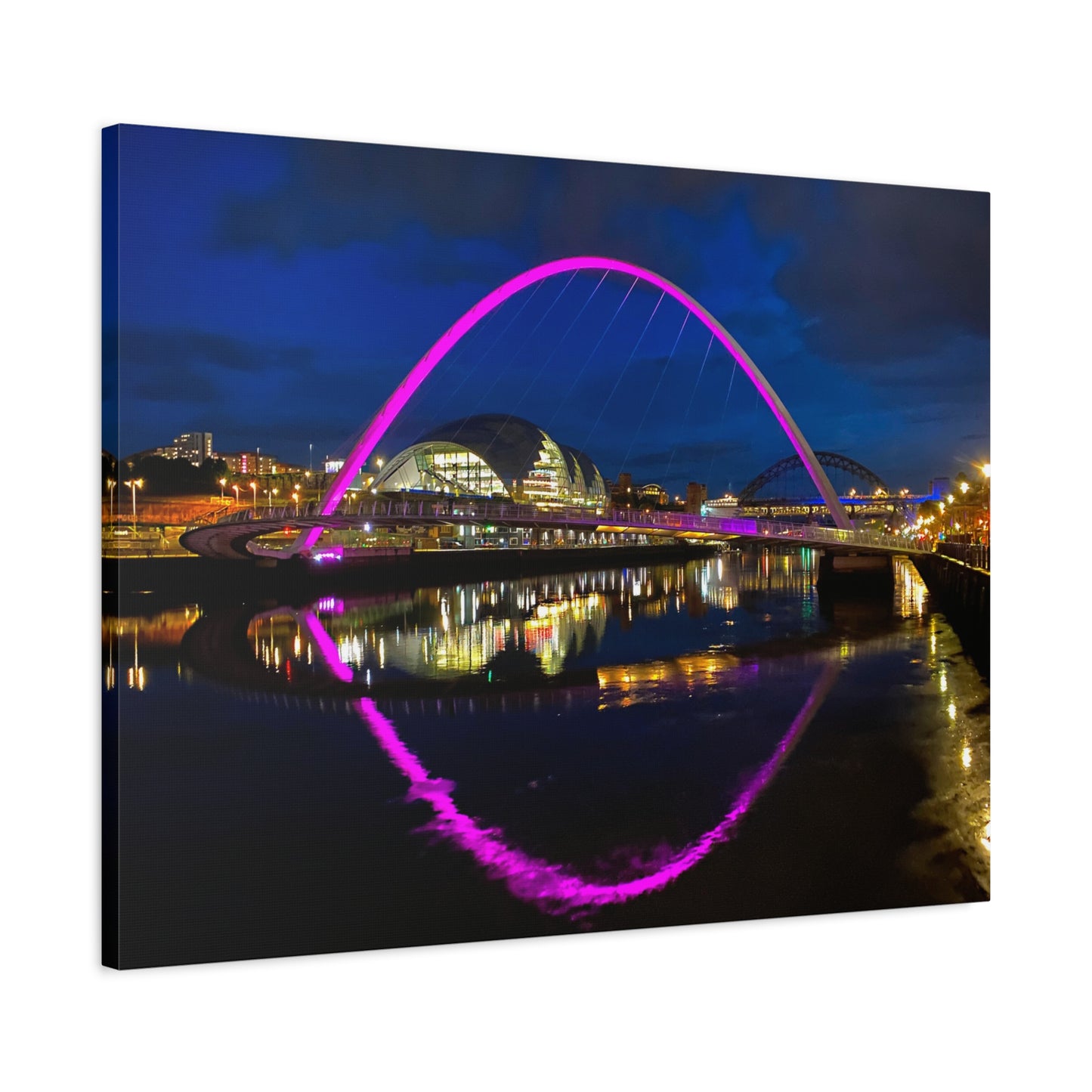 Cityscape with a prominent arch illuminated in pink, reflected in water at night.