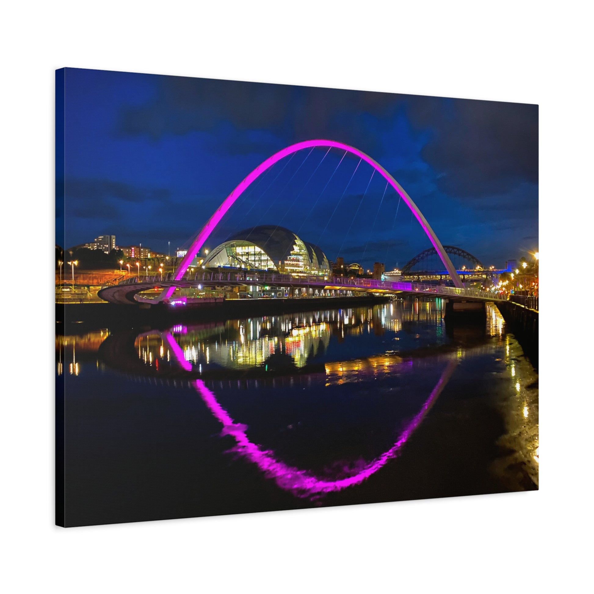 Cityscape with a prominent arch illuminated in pink, reflected in water at night.