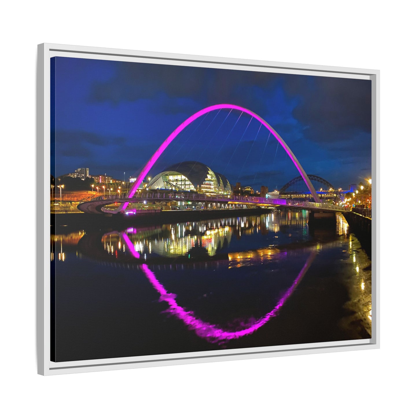 Framed photograph of a cityscape with a prominent arch at night.