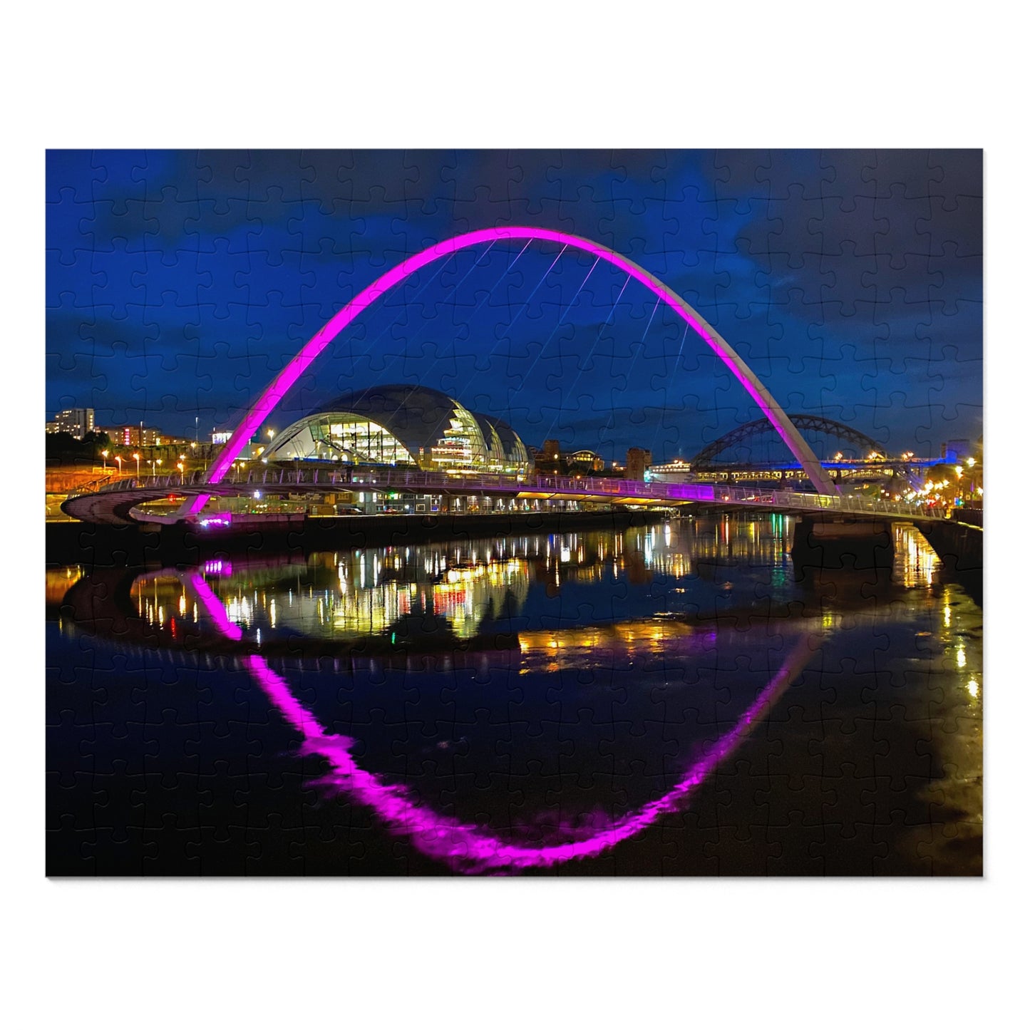 Modern bridge with a purple arch over a body of water at night.