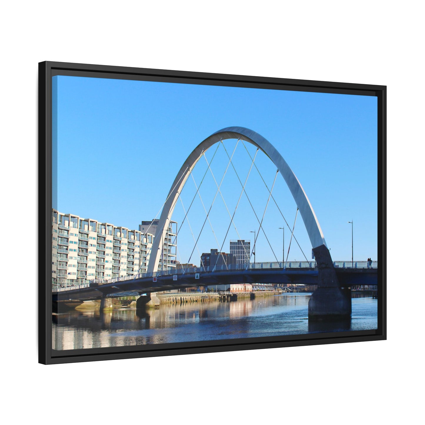Large screen displaying a bridge and buildings with a clear blue sky.