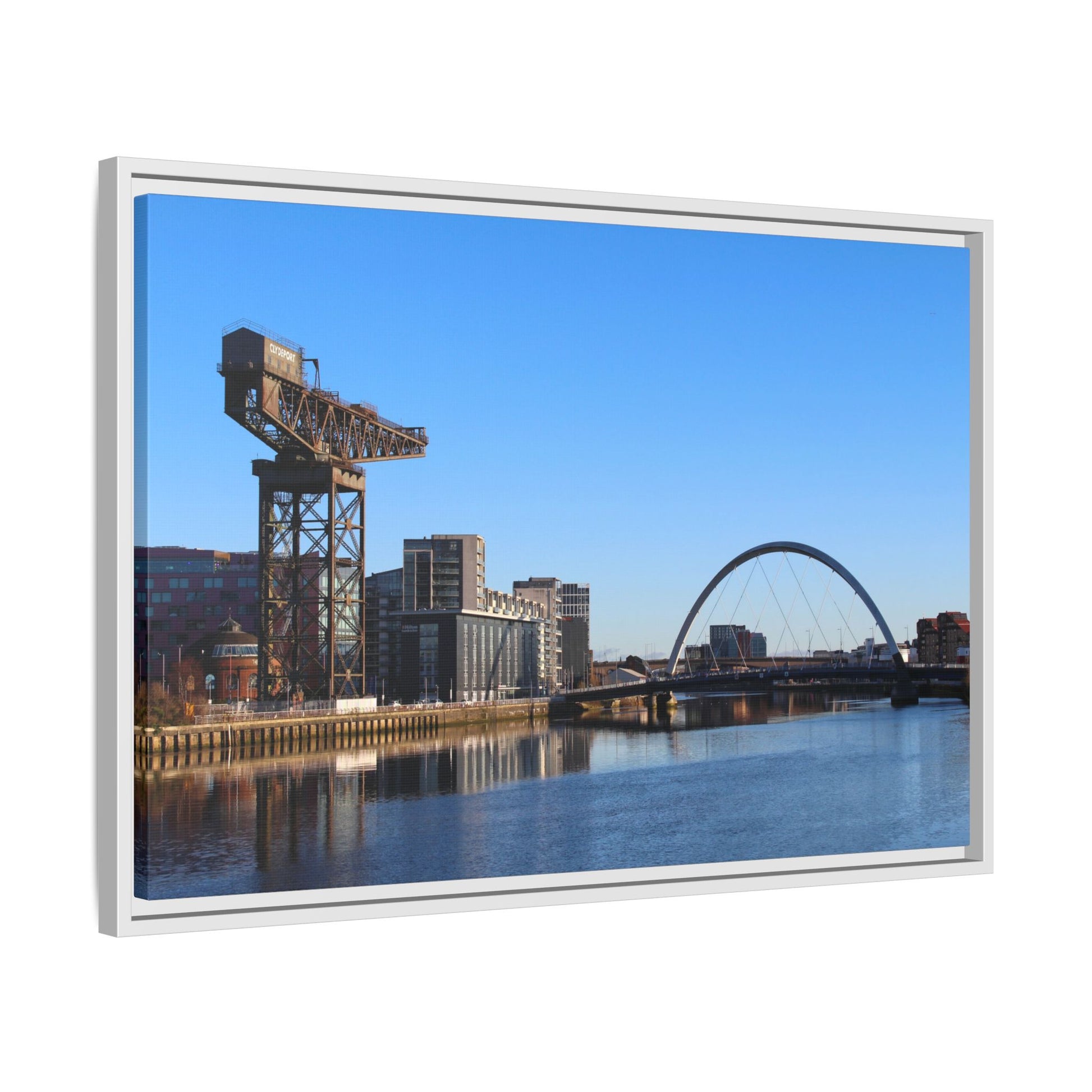 Framed photograph of a cityscape with a bridge and crane against a blue sky.