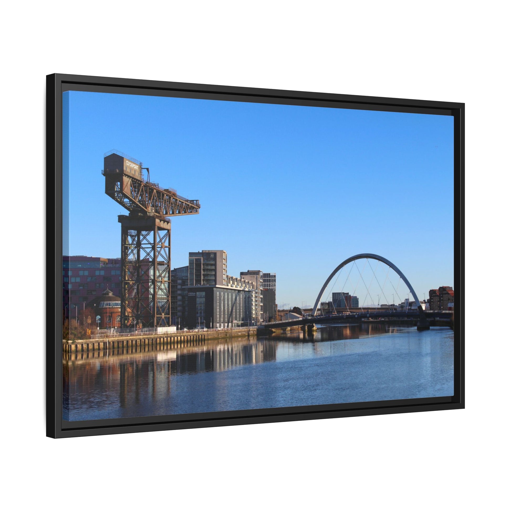 Framed photograph of a cityscape with a crane and bridge.