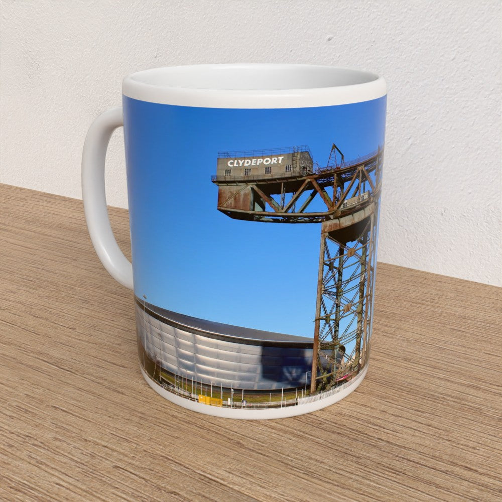 Mug with a printed design of a dockyard scene on a wooden surface.