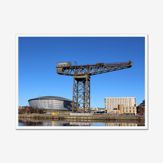 Framed photograph of a large crane with a modern building in the background