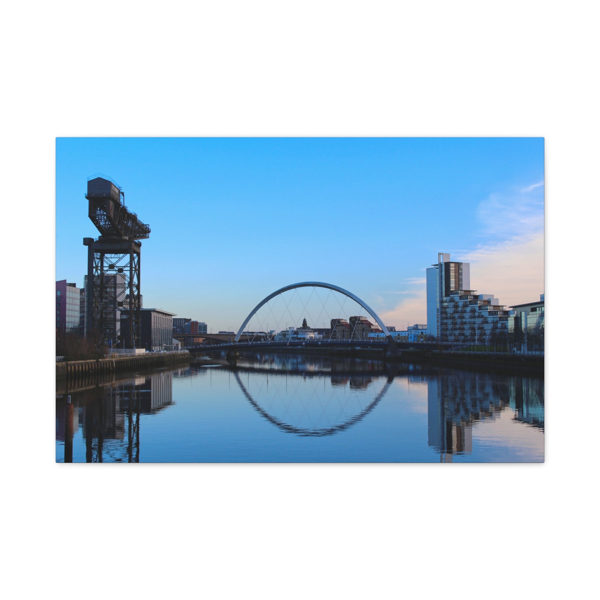Cityscape with a crane, arch, and modern buildings reflected in water