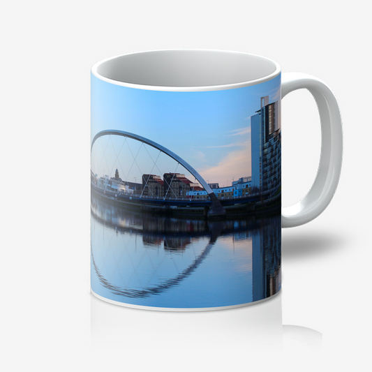 Mug with a scenic design of a bridge and buildings on a blue sky background