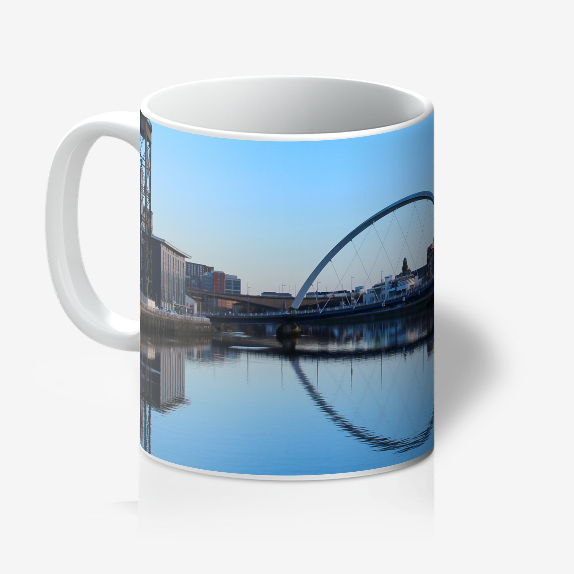 Mug with a scenic reflection of a bridge and buildings on water