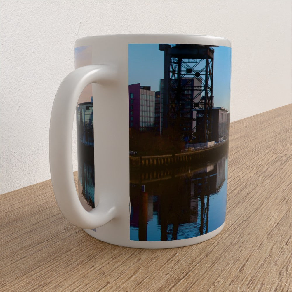 White mug with a cityscape design on a wooden surface