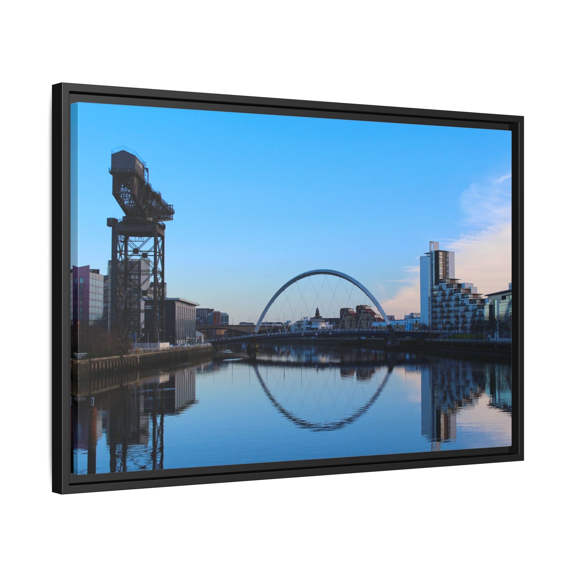 Cityscape with a crane and arch reflected in water, framed as a picture.