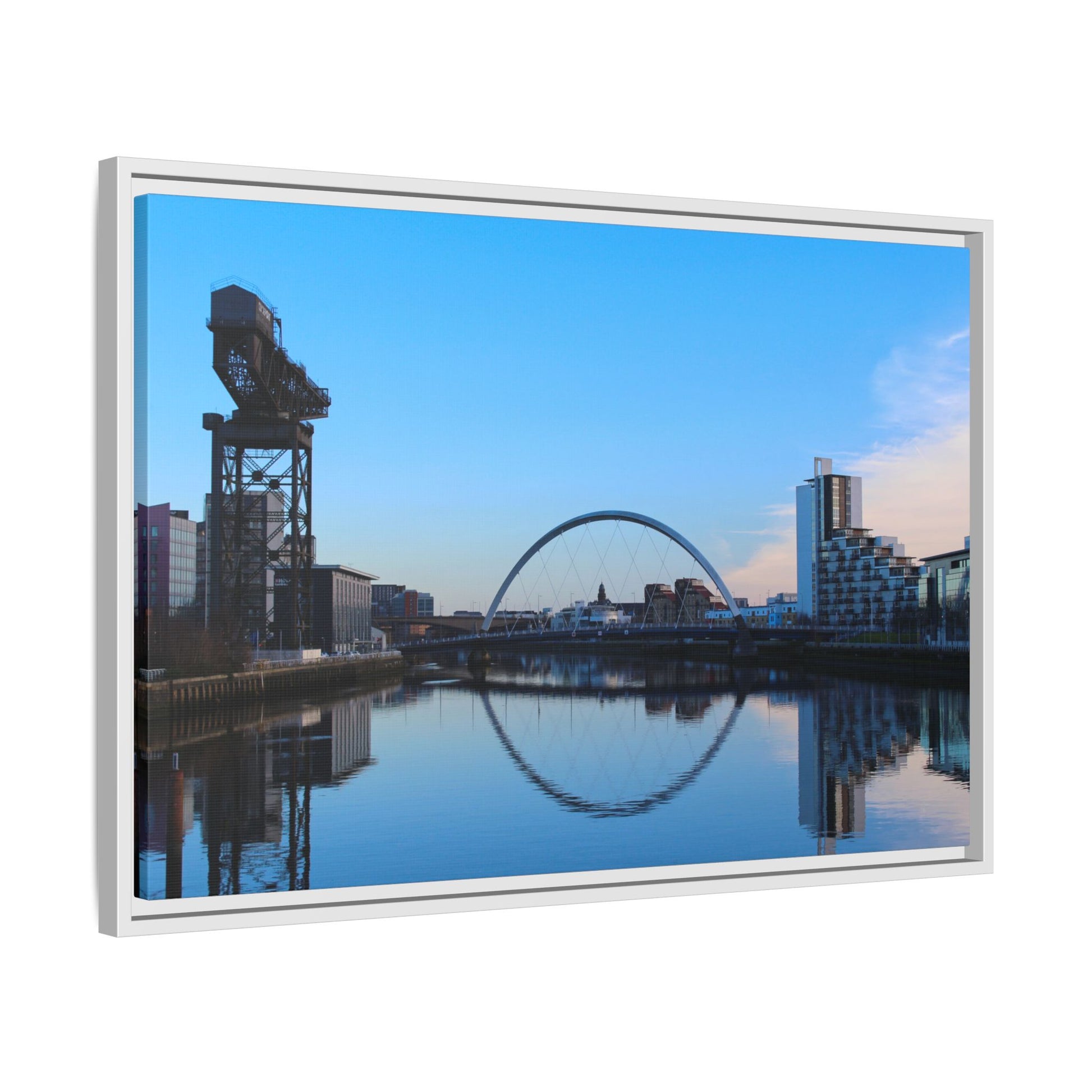Cityscape with a crane and arch reflected in water, framed as a picture.
