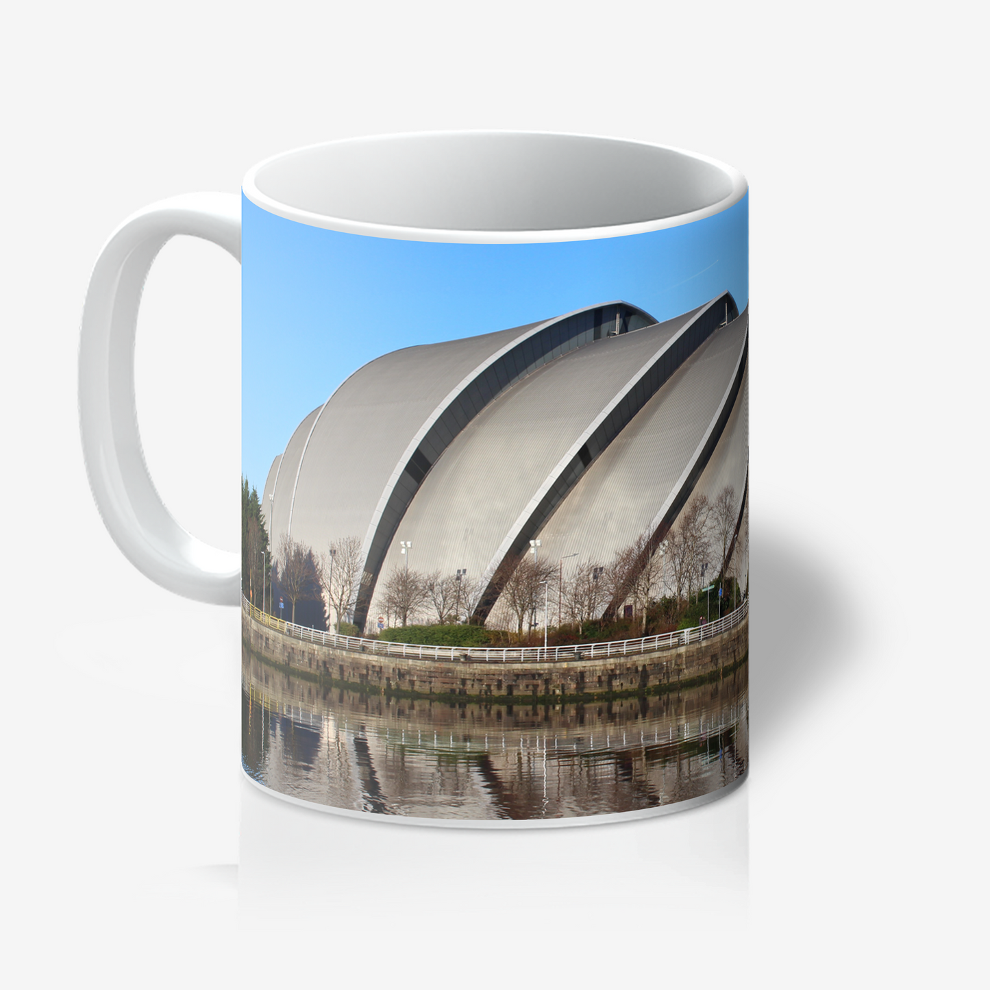 Mug with a design of a large building and water reflection on a white background