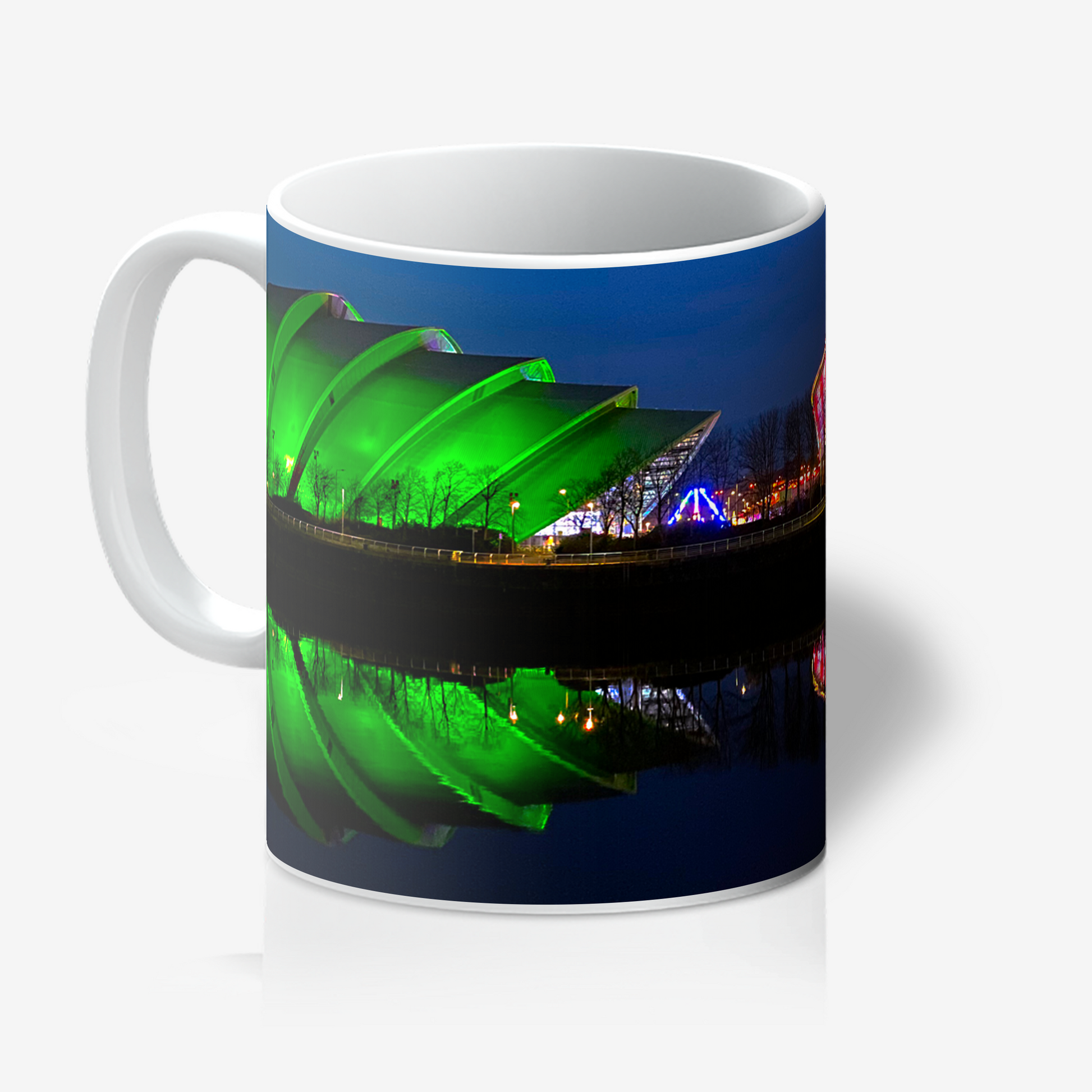 Mug with a scenic design of a green light and reflective water surface on a white background
