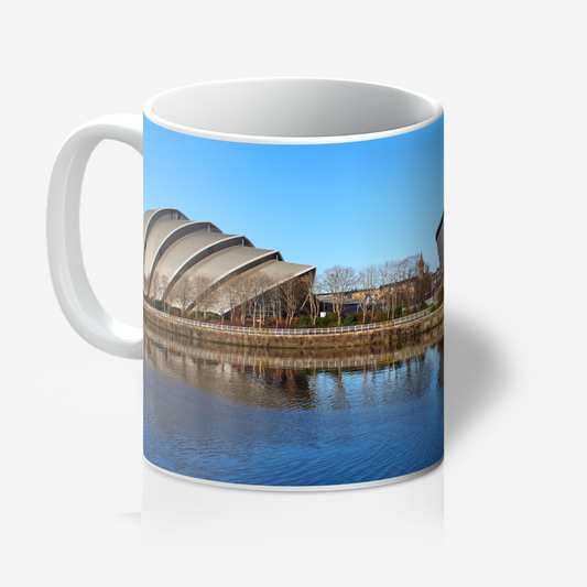 Mug with a scenic design of a building and water on a white background