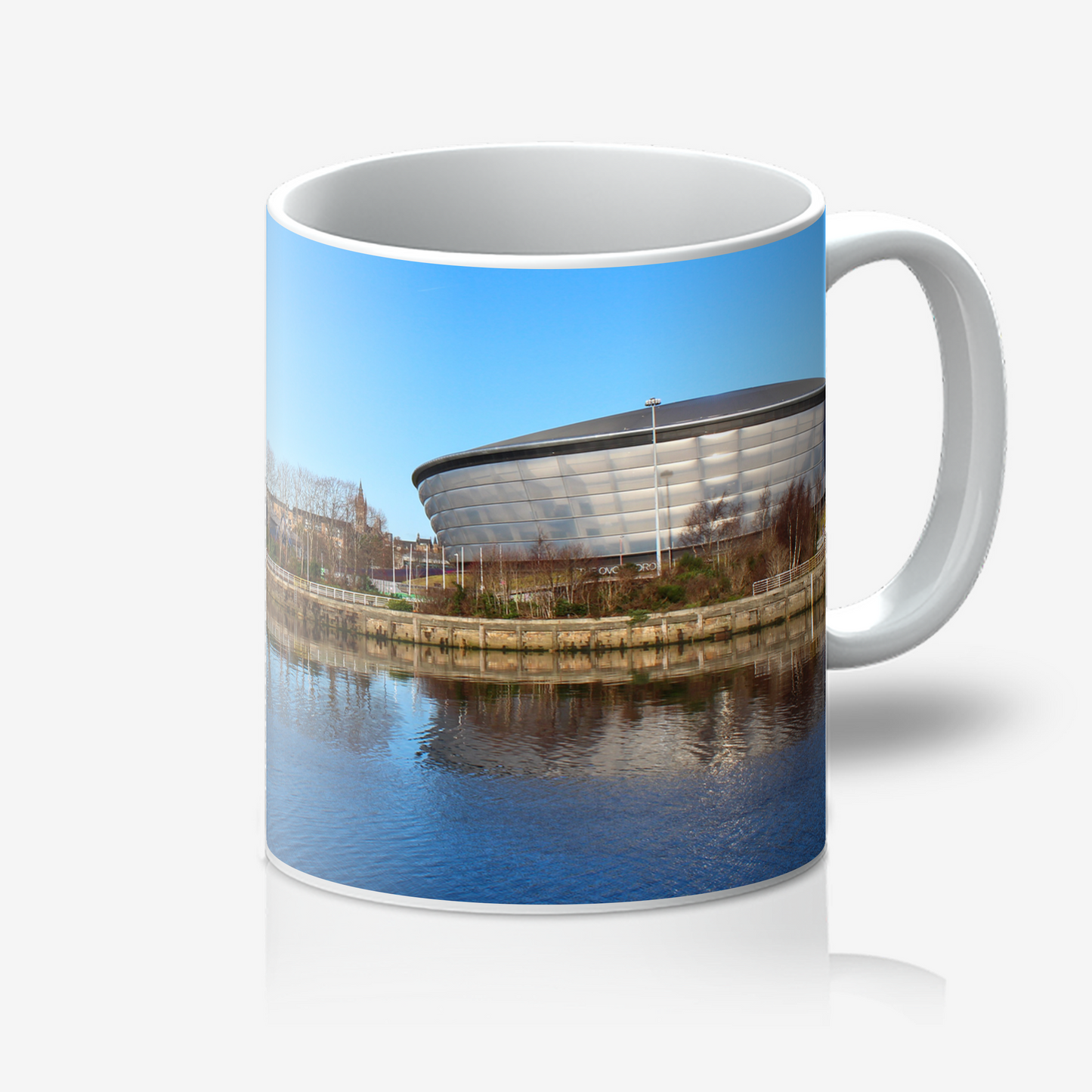 Mug with a scenic design of a building and water on a white background