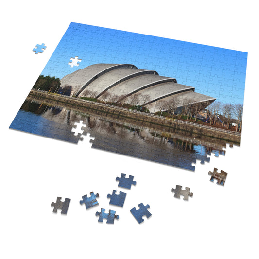 Jigsaw puzzle with completed pieces and missing ones, featuring a modern building and water reflection.