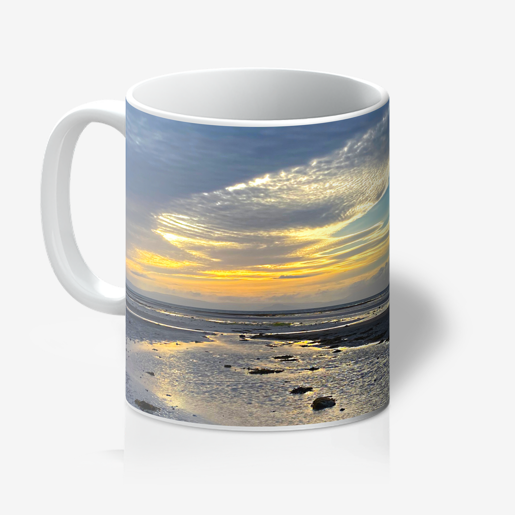 Mug with a sunset over water design on a white background