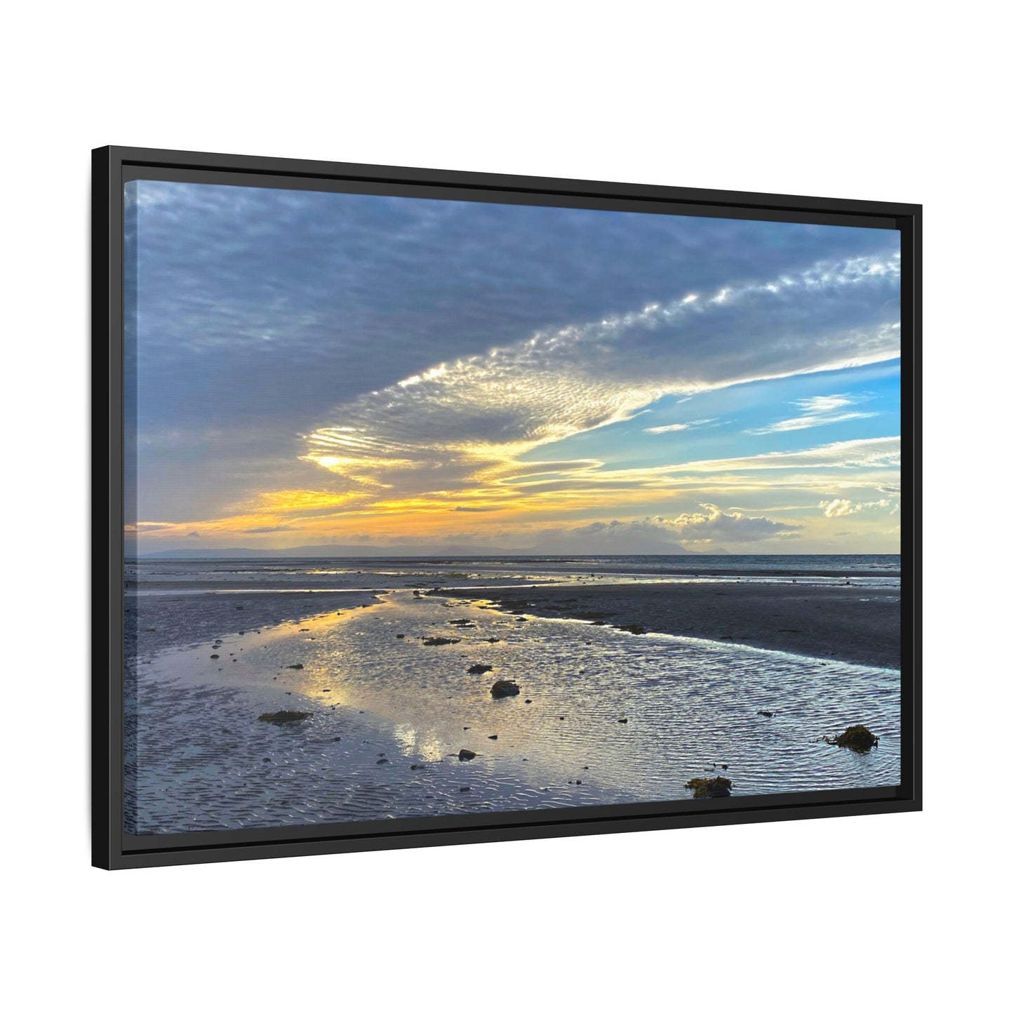 Framed artwork of a sunset over a beach with a black frame.