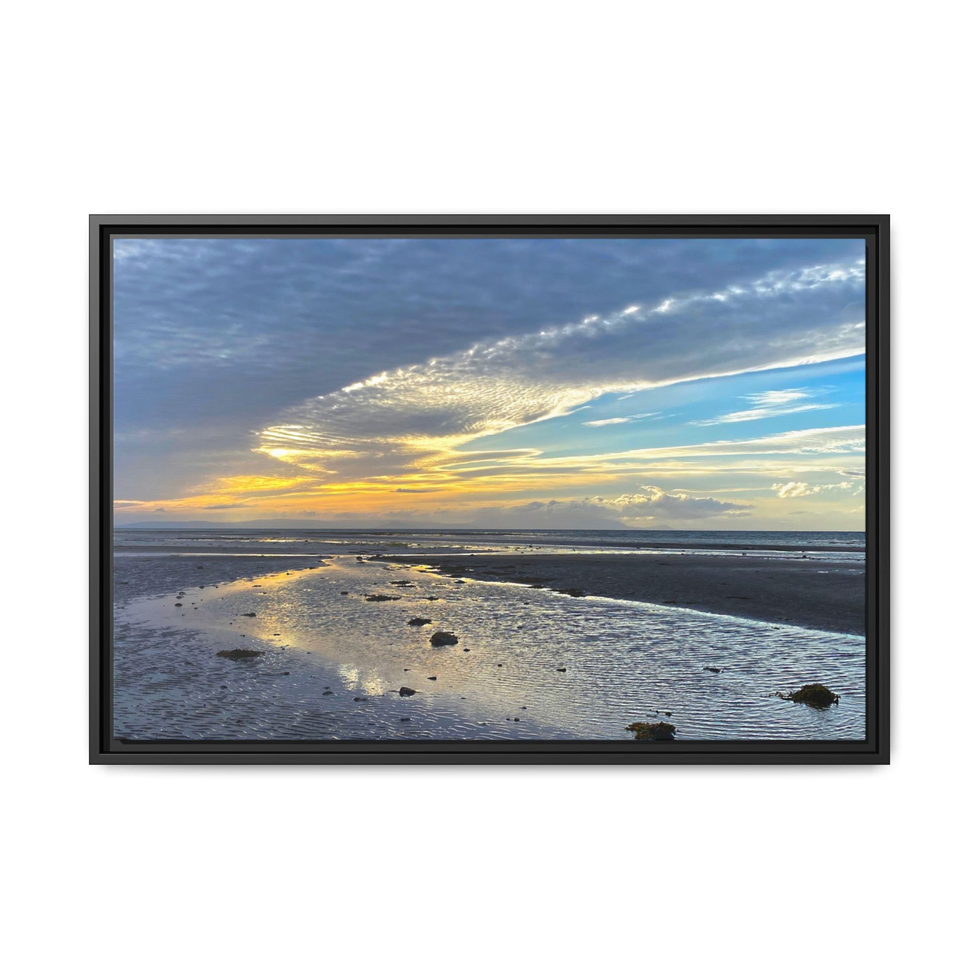 Framed artwork of a beach scene with a sunset sky.