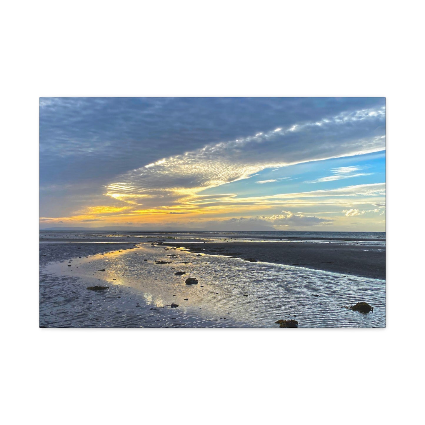 Sunset over a beach with clouds in the sky