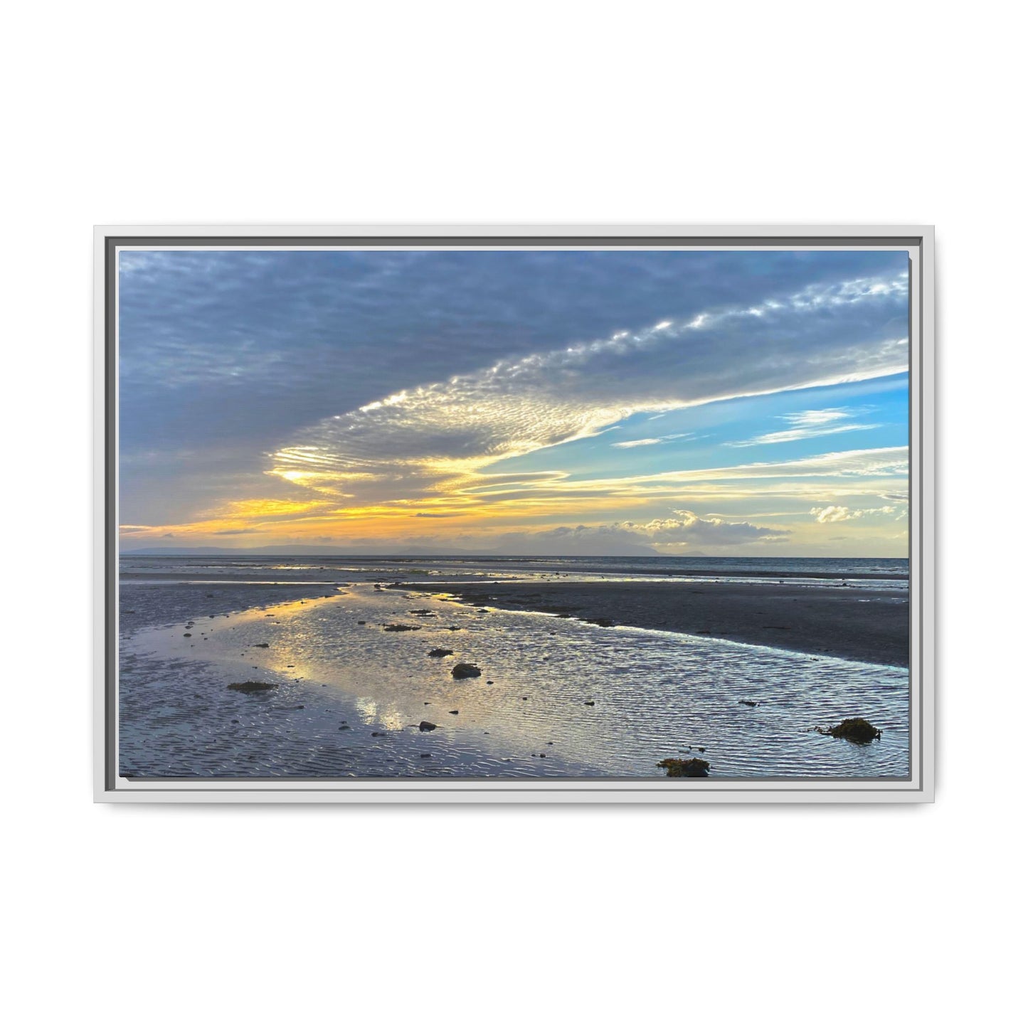 Framed artwork of a beach scene with a sunset sky.