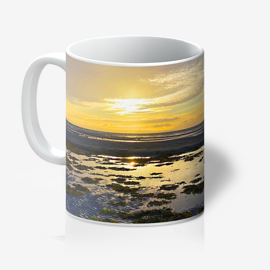 Mug with a sunset over water design on a white background