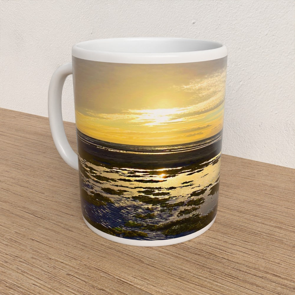 Mug with sunset design on a wooden surface