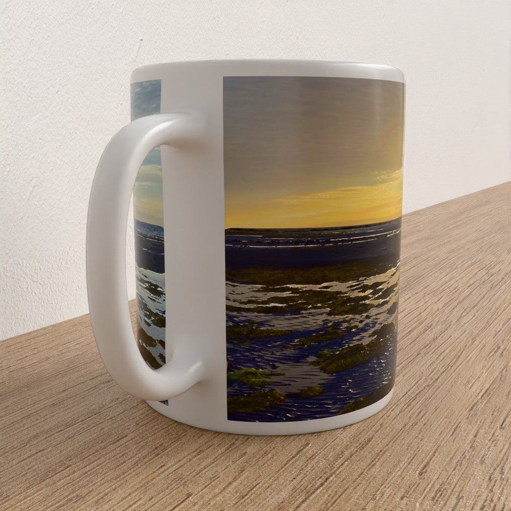 Mug with a scenic design of water and sky on a wooden surface