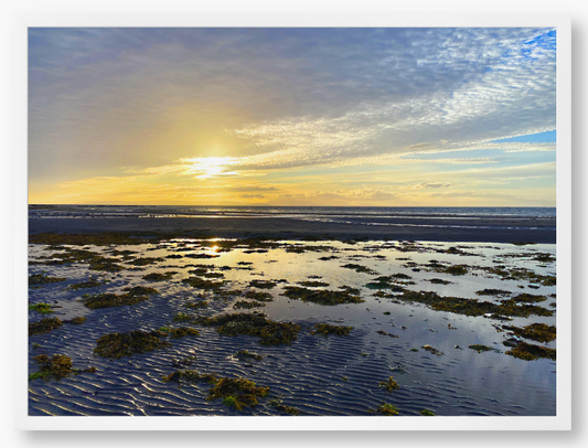 Framed Photo Of A Sunset over a coastal landscape with wet sand and low tide.