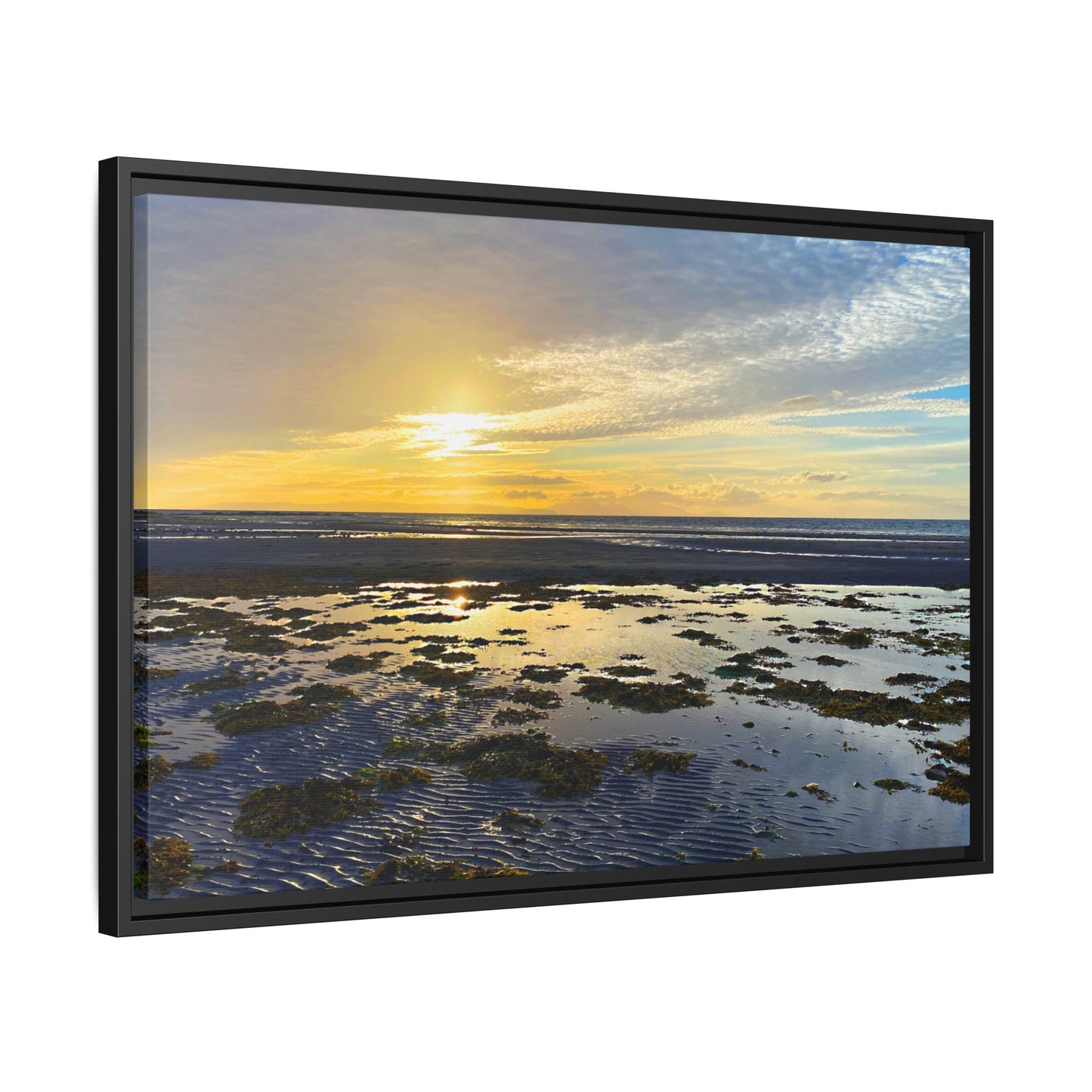 Framed artwork of a sunset over water with a black frame.
