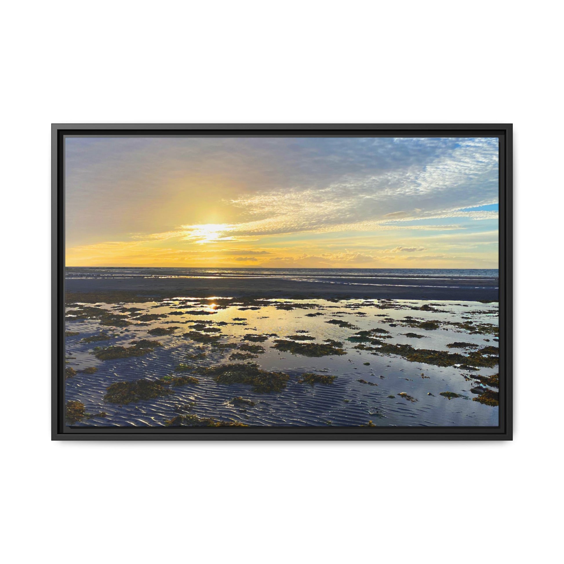 Framed artwork of a sunset over water with a black frame.